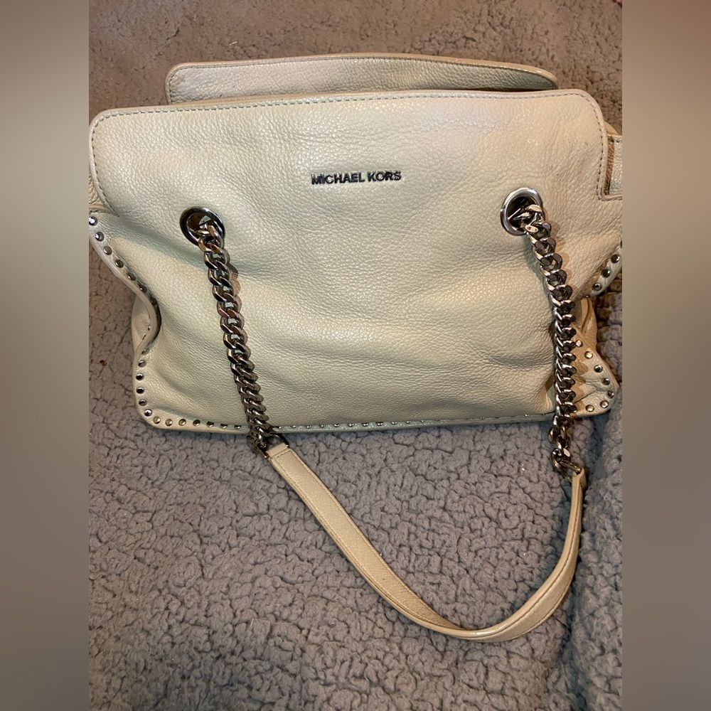 Grey Michael Kors purse, gently used, two silver chain handles, zipper to open.
